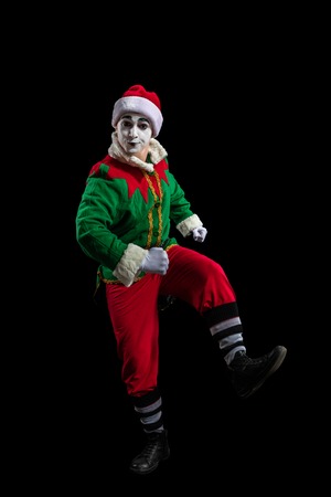 Male mime in New Year costume posing isolated on black backgroundの写真素材