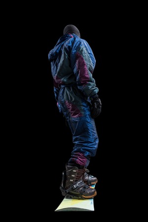 standing snowboarder isolated, rear viewの写真素材