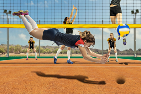 Female volleyball player reaching the ball in jumpの写真素材