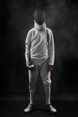 male fencer standing on black backgroundの写真素材