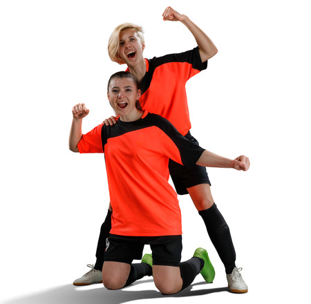 two female soccer players celebrating victory isolatedの写真素材