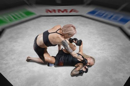 female mma fighter is punched in ground fight