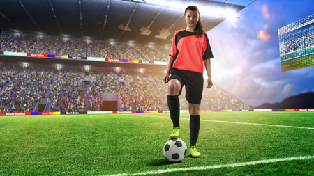 female football player in red uniform on soccer fieldの写真素材