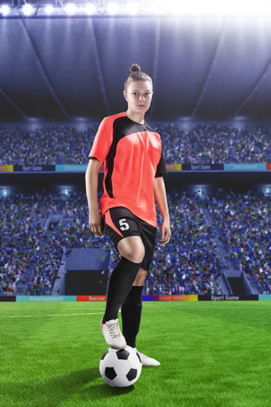 female football player in red uniform on soccer fieldの写真素材