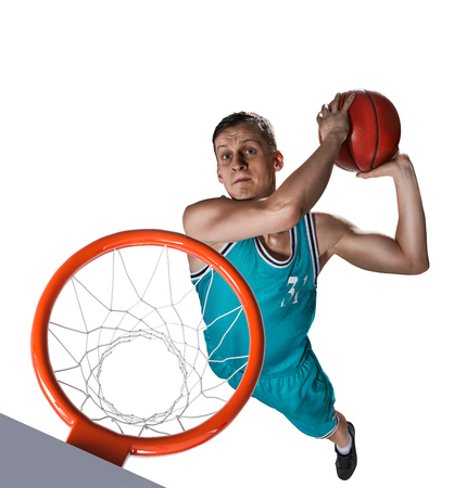 basketball player making slam dunk isolatedの写真素材