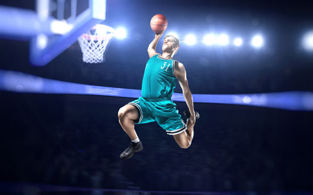 basketball player making slam dunk on basketball arenaの写真素材