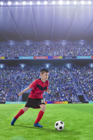 kid football player dribbling on a soccer fieldの写真素材