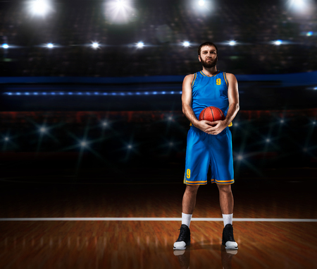 basketball player im blue uniform standing on basketball courtの写真素材
