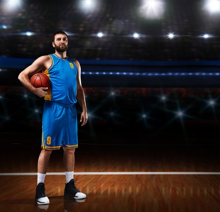 basketball player im blue uniform standing on basketball courtの写真素材