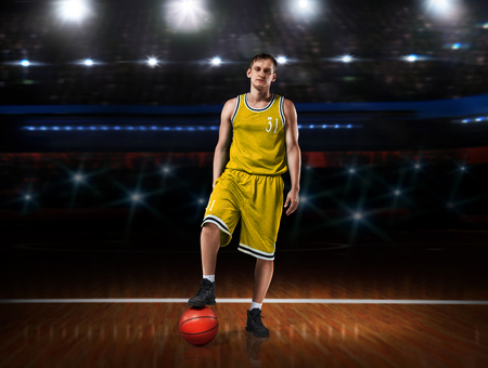 basketball player in yellow uniform standing on basketball courtの写真素材
