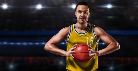 basketball player in yellow uniform standing on basketball courtの写真素材