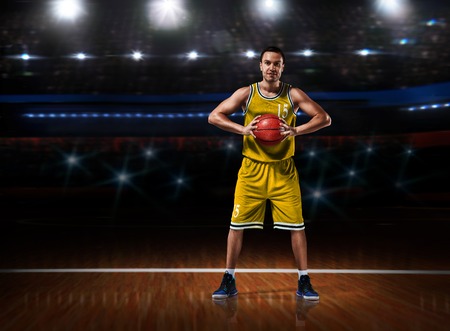 basketball player in yellow uniform standing on basketball courtの写真素材