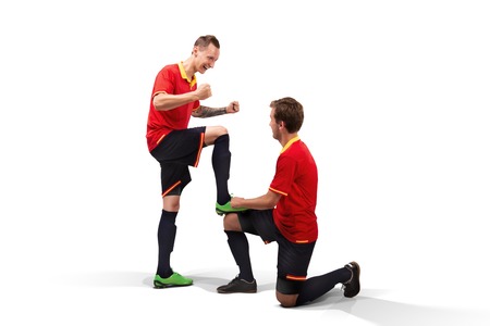 two male soccer players celebrating victory isolatedの写真素材