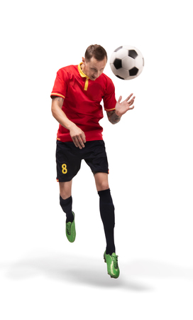 football player hitting the ball with head isolated on whiteの写真素材