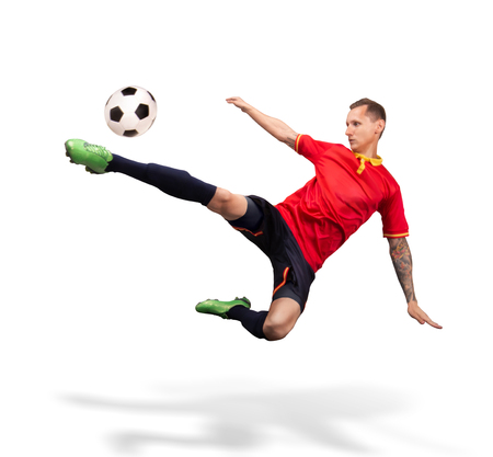 soccer player kicking the ball in the air isolated on whiteの写真素材