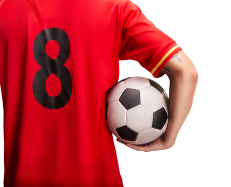 football player standing with a ball isolated on whiteの写真素材