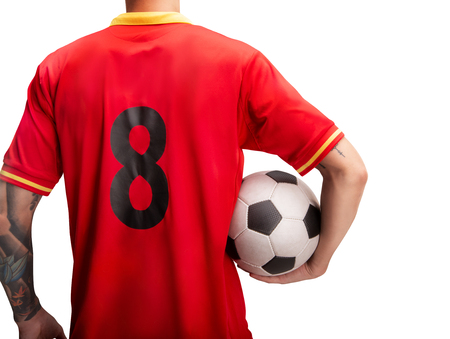 football player standing with a ball isolated on whiteの写真素材