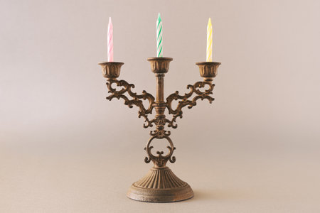 Antique candle holder with modern vibrant birthday candles. Aesthetic mix of modern and old.