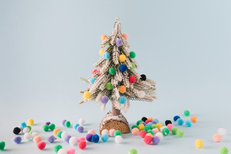 Christmas tree with vibrant and colorful pom poms. Neatly arranged scene.の写真素材