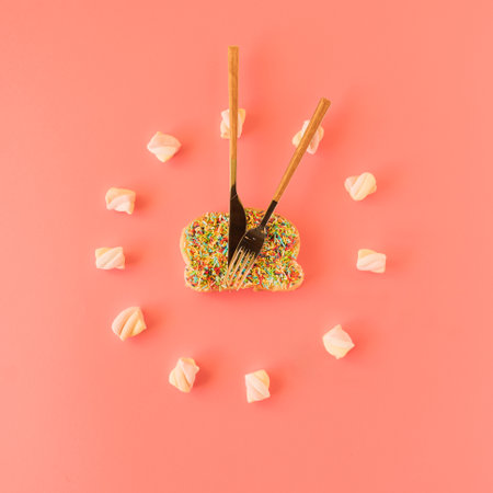 Rainbow colored sweets in form of a clock.の写真素材