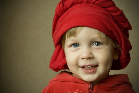 portrait of a child in red on a backgroundの写真素材