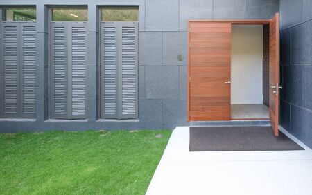 Wooden front door half openedの写真素材