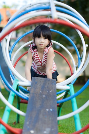 Cute little girl enjoys playing in a childrenの写真素材