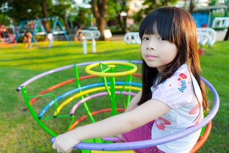 Cute little girl enjoys playing in a childrenの写真素材