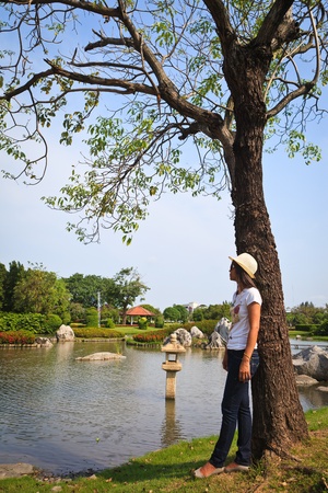 Woman standing by the treeの写真素材