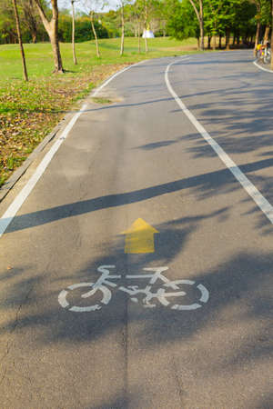 Bicycle sign with bicycle path in parkの写真素材