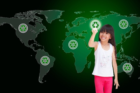 Little girl pressing recycle icon on world mapの写真素材