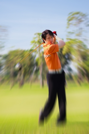 Golfer shooting a golf ballの写真素材
