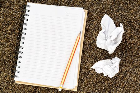 Blank note book with crumpled paperの写真素材