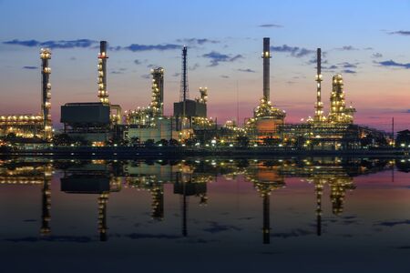 Refinery plant area at twilight with reflection in riverの写真素材
