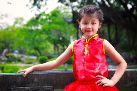 Smiling little asian girl in chinese style dress, Outdoor portraitの写真素材