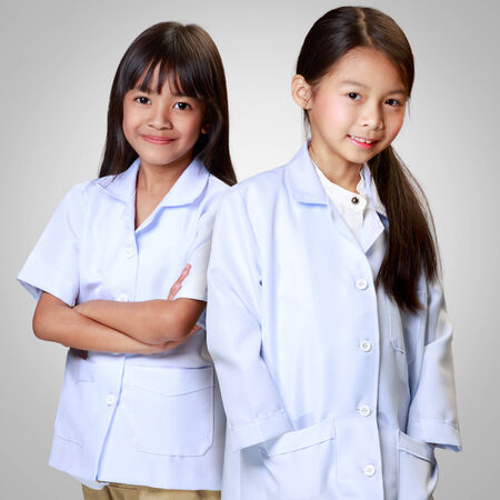Little asian girls in medical profession, Isolated over greyの写真素材