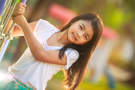 Happy little asian girl on the playgroundの写真素材