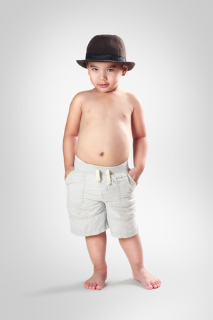 Adorable little asian boy posing, Isolated on grey backgroundの写真素材