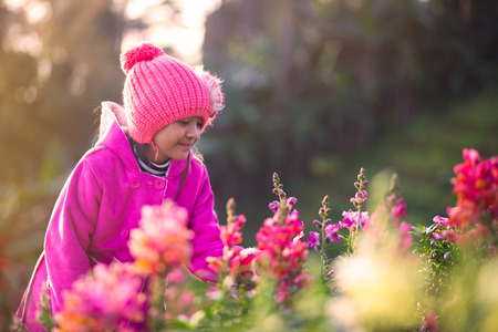 Little asian girl with flower fields in winter, Outdoor portraitの写真素材