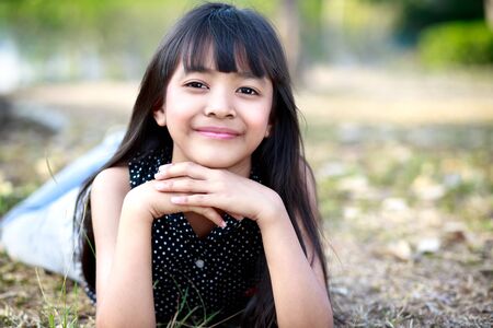 Happy little asian girl having fun at the park, Outdoor portraitの写真素材
