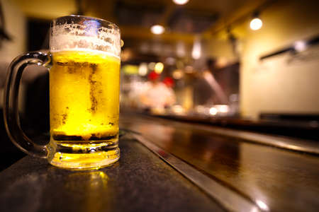 Glass of light beer on a restaurant