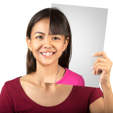 Studio portrait of young mother compare her face with her daughter picture