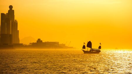 Duk Ling Ride at sunset Traditional wooden sailboat sailing in victoria harborHong Kongの写真素材