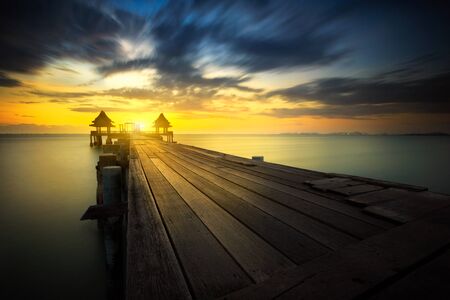 Wooded bridge at sunsetの写真素材