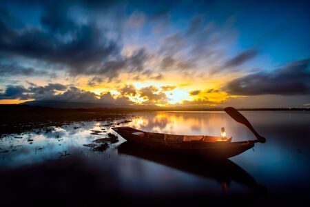 Sunrise over the lake the first rays of sunの写真素材
