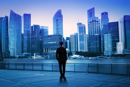 Businessman standing at night cityscape, Business vision conceptの写真素材