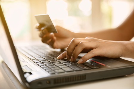 Hands holding credit card and-using laptop online shopping