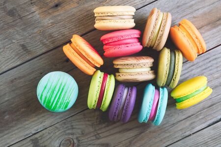 Tasty french macarons on a wooden table with vintage color tone, Macarons  is a French sweet meringue-basedの写真素材