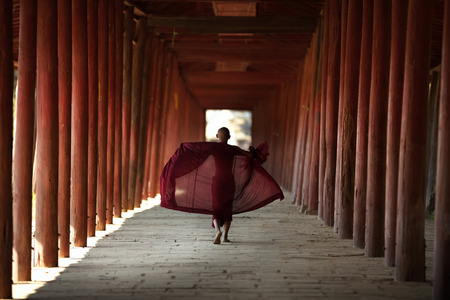 Little monk walking at old temple, Salay Bagan Myanmarの写真素材