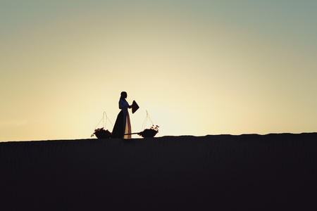 Mui Ne white sand with woman in vietnam culture traditional dress, Vietnamの写真素材